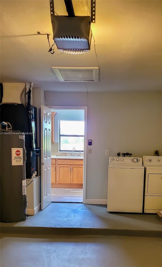 interior space featuring separate washer and dryer, sink, and water heater