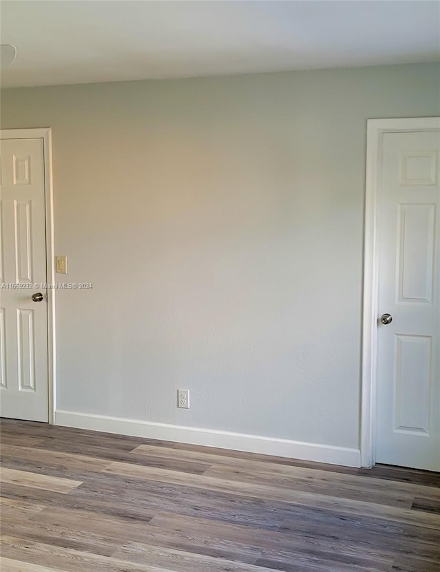 spare room featuring wood-type flooring