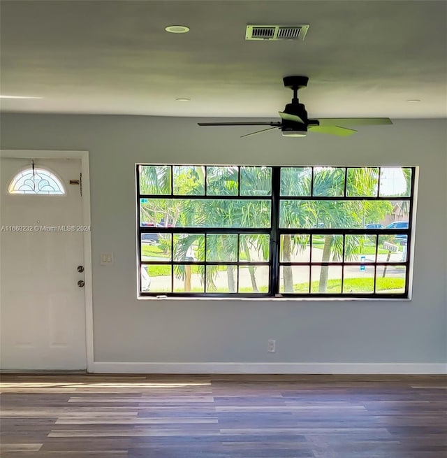 foyer with ceiling fan and wood-type flooring