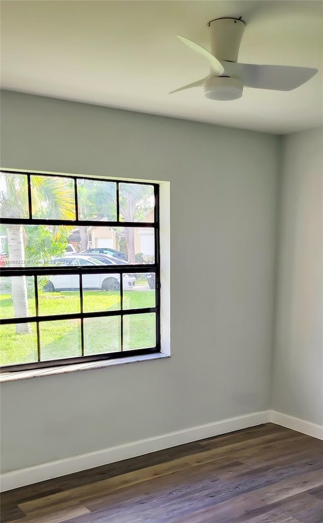 unfurnished room featuring ceiling fan and dark wood-type flooring