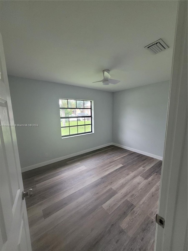 empty room with hardwood / wood-style floors and ceiling fan