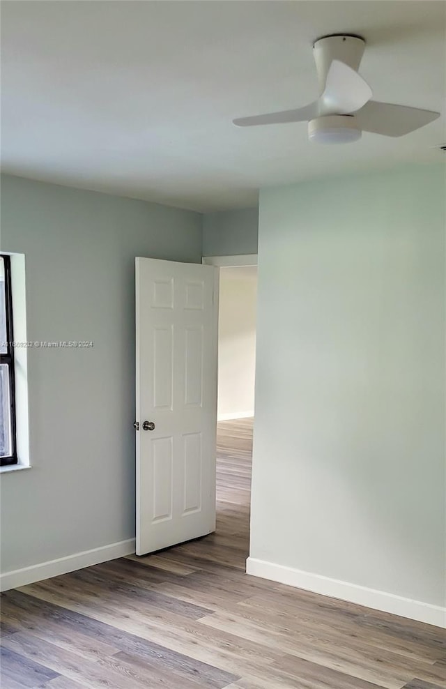 empty room featuring ceiling fan and light wood-type flooring