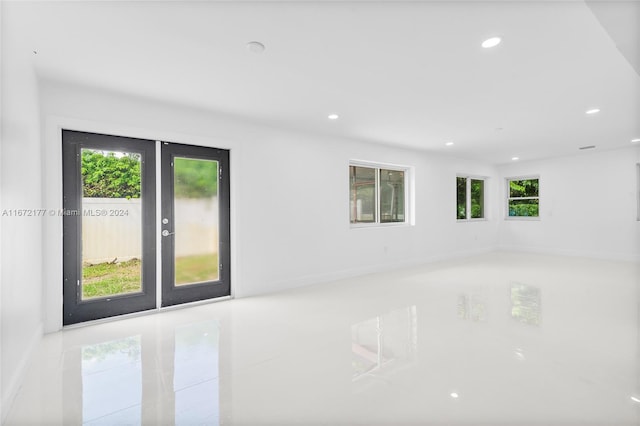 unfurnished room featuring french doors