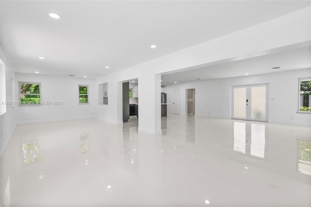 spare room with french doors and light tile patterned floors