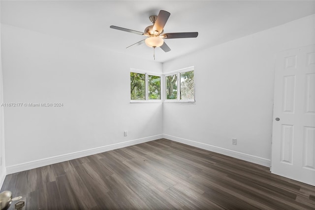 unfurnished room featuring ceiling fan and dark wood-type flooring