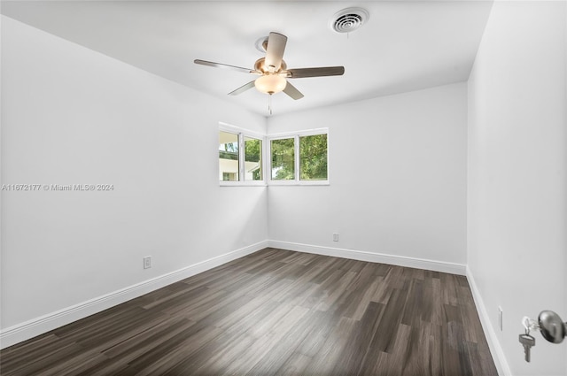 unfurnished room with ceiling fan and dark hardwood / wood-style flooring