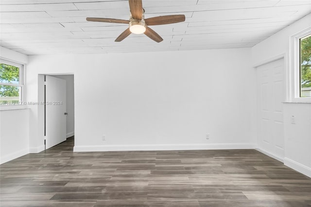 unfurnished room with ceiling fan and dark wood-type flooring