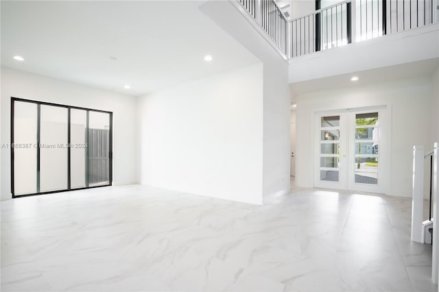 unfurnished room featuring french doors