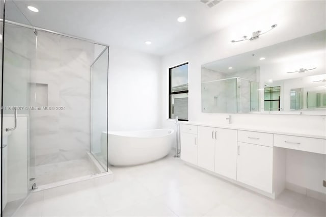 bathroom with vanity, plus walk in shower, and tile patterned floors