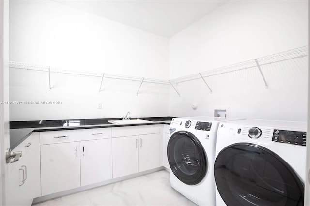 clothes washing area featuring cabinets, separate washer and dryer, and sink