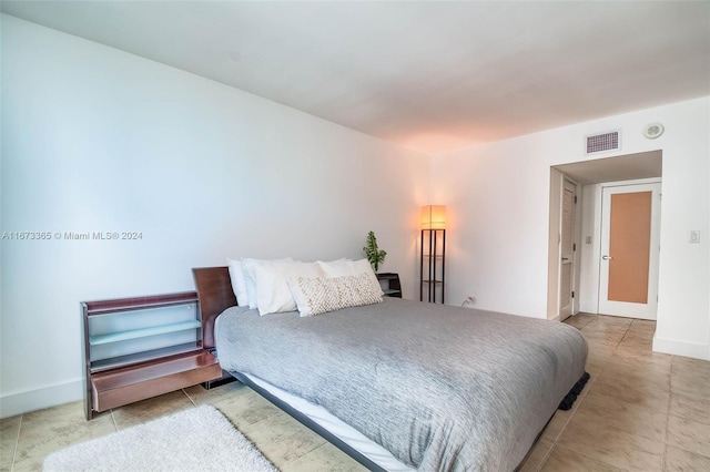 bedroom with light tile patterned floors