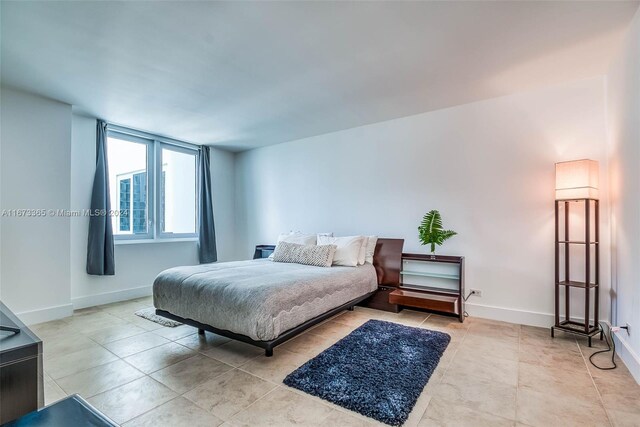 bedroom with light tile patterned floors