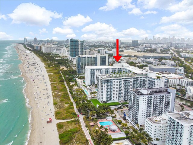 bird's eye view with a water view and a beach view