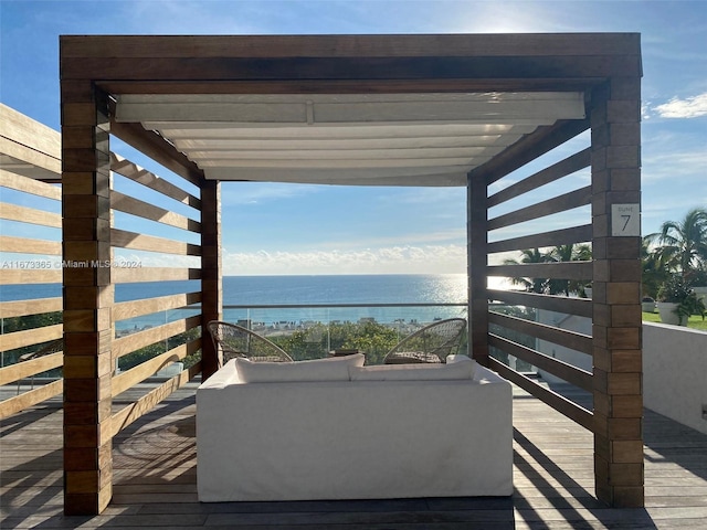 wooden deck with outdoor lounge area and a water view