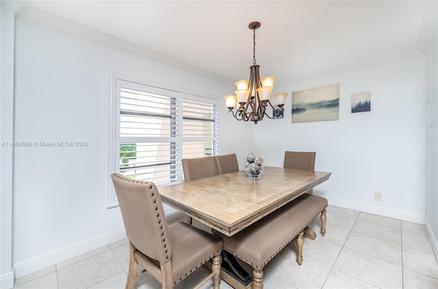 dining area featuring a notable chandelier, light tile patterned floors, and crown molding