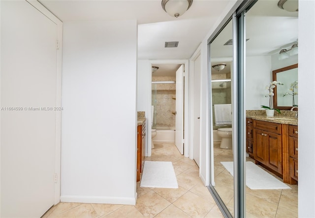 bathroom with vanity, tile patterned flooring, and toilet