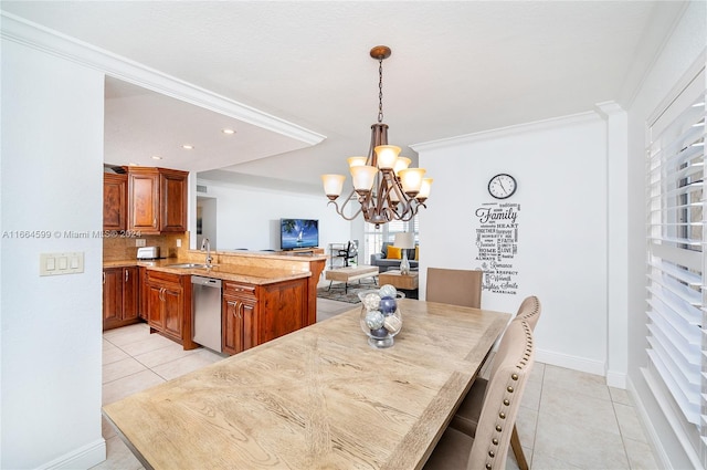 dining room with ornamental molding, light tile patterned floors, an inviting chandelier, and sink