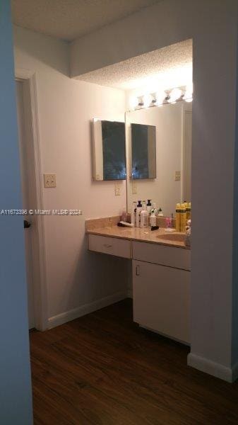 3204 Glenmoor Dr Unit 3204, West Palm Beach, FL 33409 - bathroom featuring wood finished floors, vanity, and baseboards