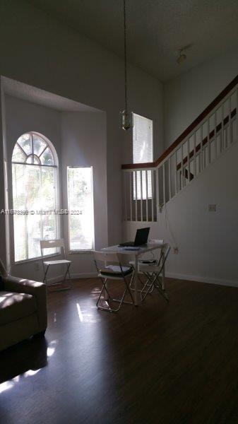 3204 Glenmoor Dr Unit 3204, West Palm Beach, FL 33409 - dining room featuring wood finished floors, baseboards, and stairs