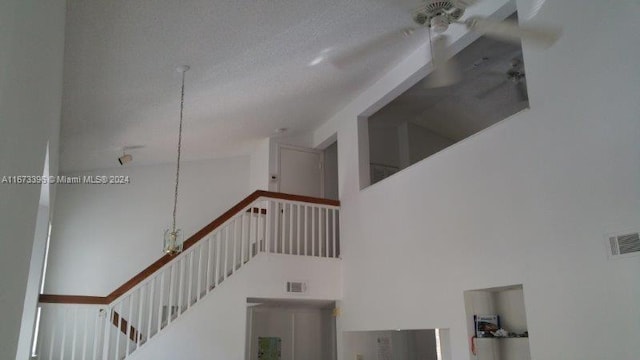 3204 Glenmoor Dr Unit 3204, West Palm Beach, FL 33409 - stairway featuring a towering ceiling