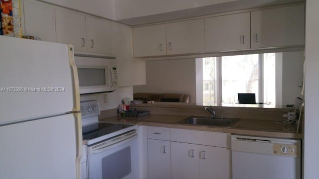 3204 Glenmoor Dr Unit 3204, West Palm Beach, FL 33409 - kitchen featuring white appliances, a sink, white cabinets, and light countertops