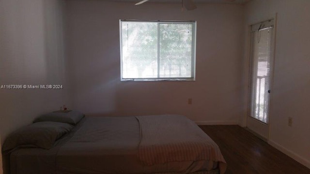 3204 Glenmoor Dr Unit 3204, West Palm Beach, FL 33409 - bedroom with baseboards, wood finished floors, and multiple windows