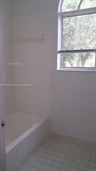 3204 Glenmoor Dr Unit 3204, West Palm Beach, FL 33409 - full bathroom featuring tile patterned floors, baseboards, and shower / bath combination