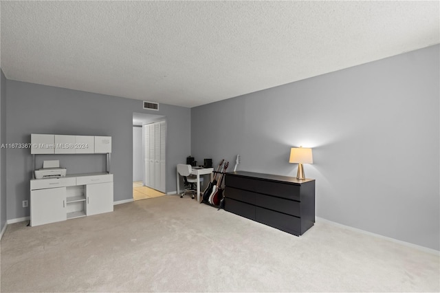 carpeted bedroom with a textured ceiling