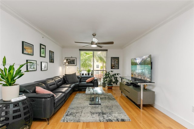 living room with light hardwood / wood-style flooring, ceiling fan, and ornamental molding