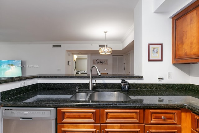 kitchen with hanging light fixtures, dishwasher, crown molding, dark stone counters, and sink