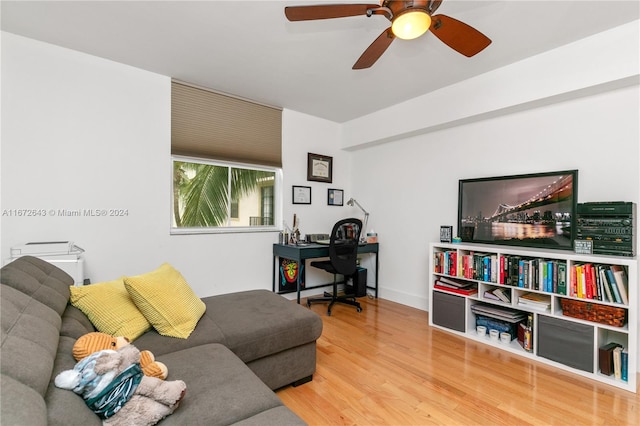 living room with hardwood / wood-style floors and ceiling fan