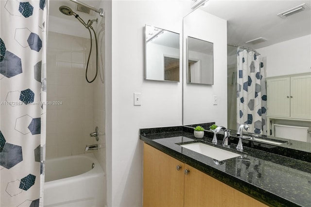 bathroom with shower / bath combo and vanity