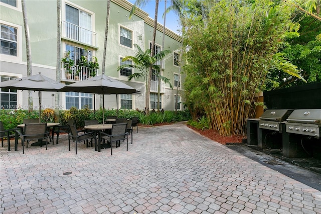 view of patio with grilling area and a balcony