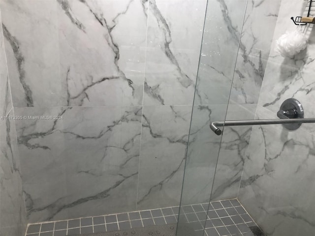 bathroom with tiled shower