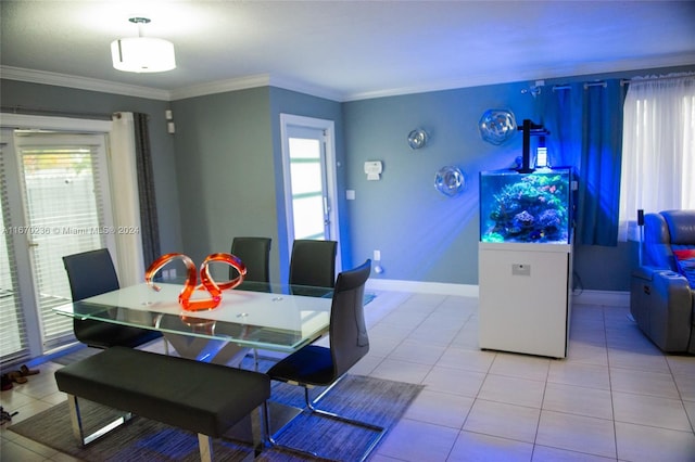 dining space with a healthy amount of sunlight, crown molding, and light tile patterned floors