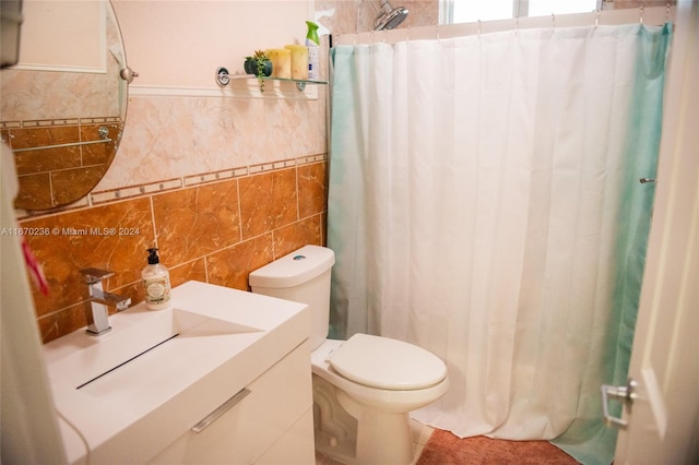 bathroom with vanity, tasteful backsplash, curtained shower, tile walls, and toilet