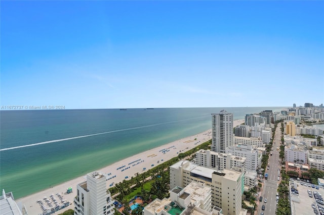 bird's eye view featuring a water view and a beach view