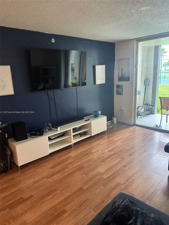 living room with hardwood / wood-style flooring and a textured ceiling