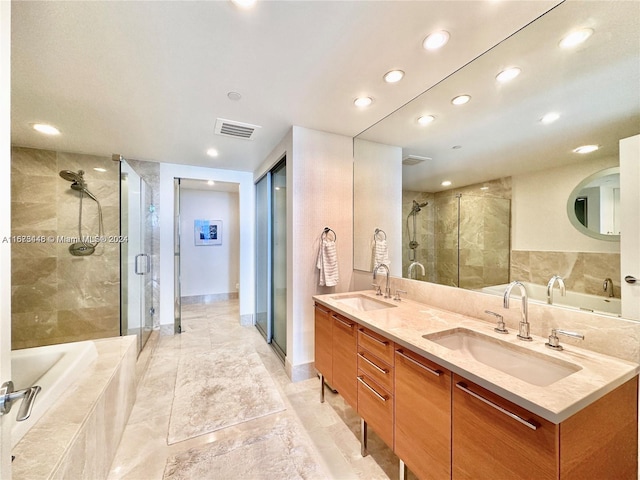 bathroom with vanity and separate shower and tub