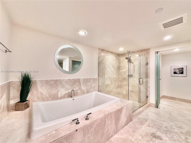 bathroom with separate shower and tub