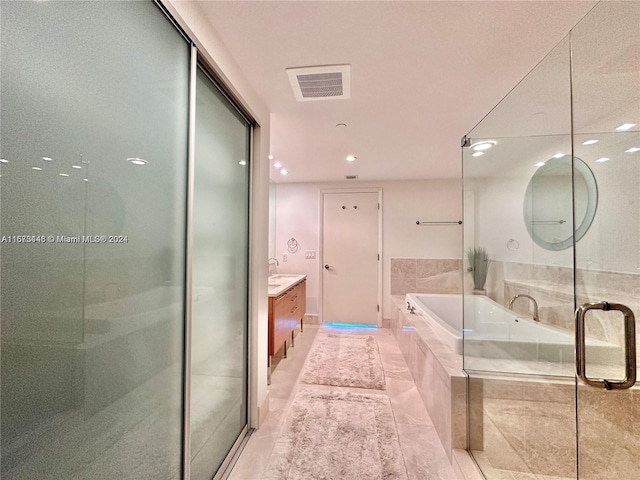 bathroom with tile patterned flooring, vanity, and independent shower and bath