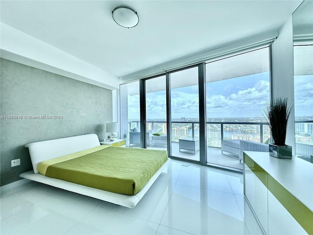 bedroom featuring multiple windows, light tile patterned floors, floor to ceiling windows, and access to exterior