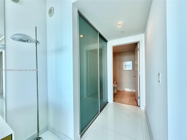 hallway featuring light tile patterned floors