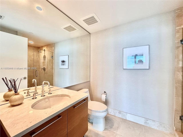 bathroom with tile patterned floors, vanity, toilet, and a shower with shower door