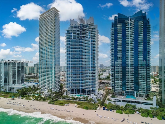 view of city featuring a water view and a beach view