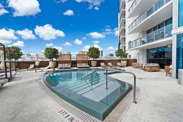 view of pool featuring an outdoor living space and a patio