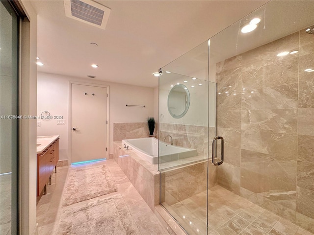 bathroom with tile patterned flooring, vanity, and separate shower and tub