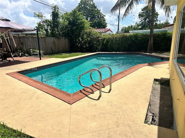 view of swimming pool with a patio area