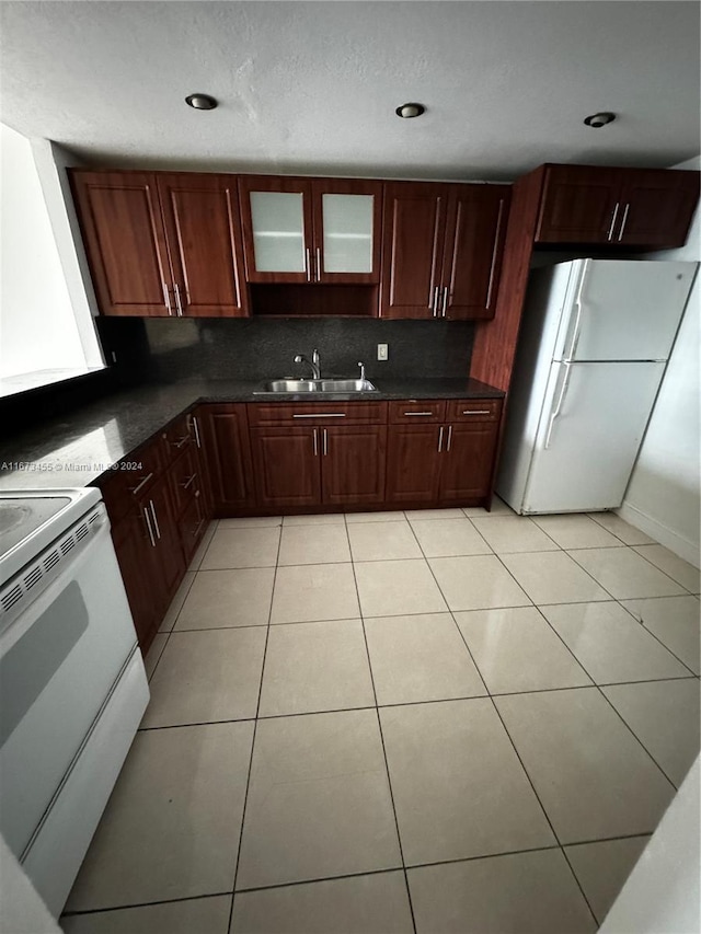 kitchen featuring white appliances, light tile patterned floors, tasteful backsplash, and sink