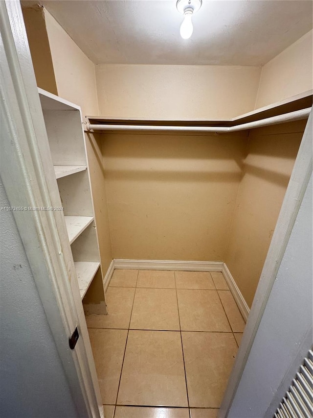 walk in closet with light tile patterned floors